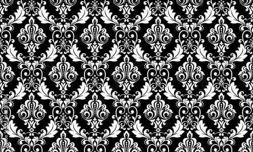 Wallpaper in the style of Baroque. Seamless vector background. White and black floral ornament. Graphic pattern for fabric, wallpaper, packaging. Ornate Damask flower ornament