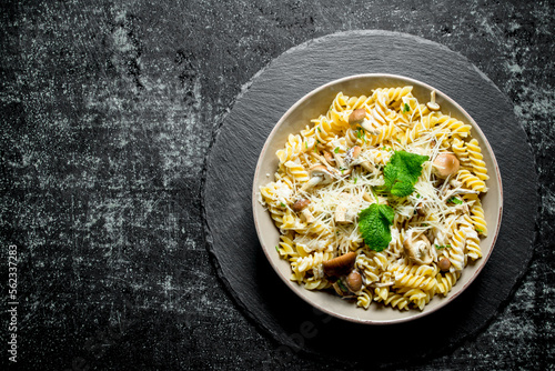 Fusilli pasta with mushrooms and cheese.