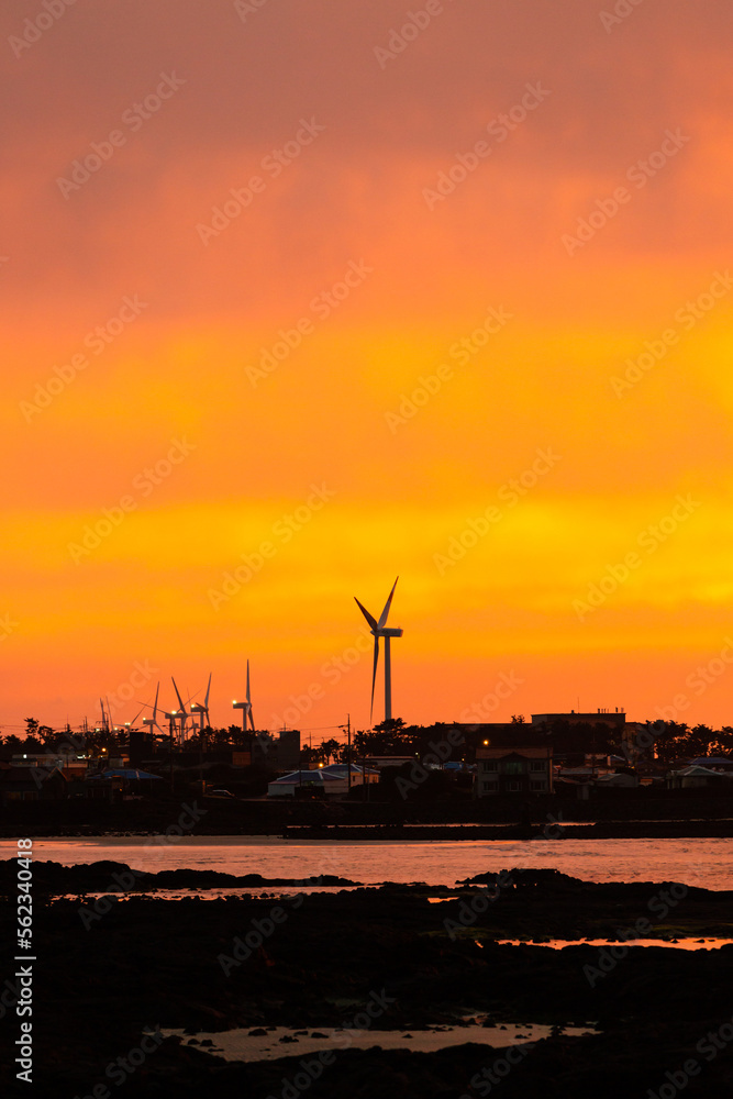 wind turbine at sunset. the evening sea tinged with twilight.