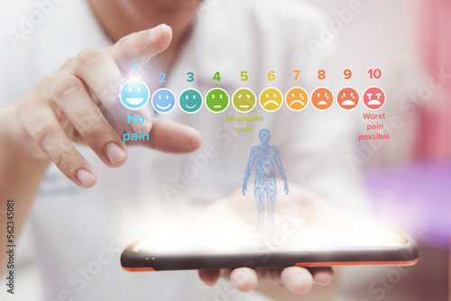 Doctor touching of pain measurement scale colorful icon virtual screen interface, emotions from happy blue to red crying, medical technology and futuristic concept.
