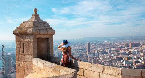 Back view of traveler girl in Alicante, Santa Barbara castle and panoramic city landscape view- Spain photo