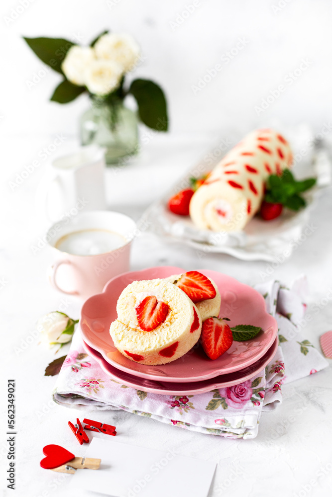 Homemade festive Swiss roll with strawberries and cream. Selective focus.