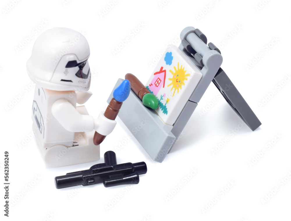 Naklejka premium Lego minifigure of warrior Star Wars as artist is painting a build isolated on white. Editorial illustrative image of popular plastic toy constructor.