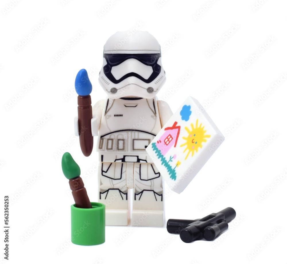 Naklejka premium Lego minifigure of warrior Star Wars as artist is painting a build isolated on white. Editorial illustrative image of popular plastic toy constructor.