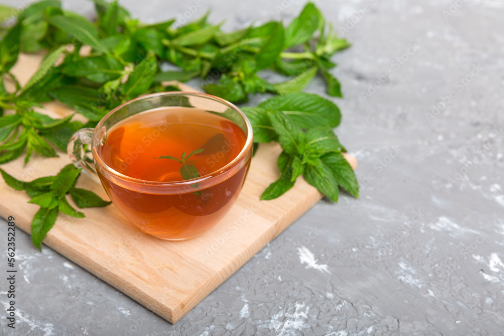 Cup of mint tea on table background. Green tea with fresh mint top view with copy space Cup of mint tea on table background. Green tea with fresh mint top view with copy space