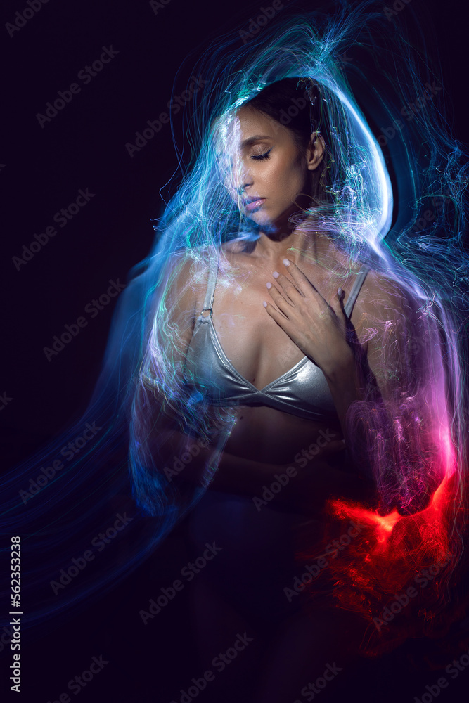 portrait cyber futuristic elegant lady in a silver swimsuit vogue look isolated vibrant gradient colorful effect background. Woman is in a multicolored aura.