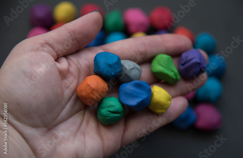 Colorful pieces of plasticine prepared for modeling in hands