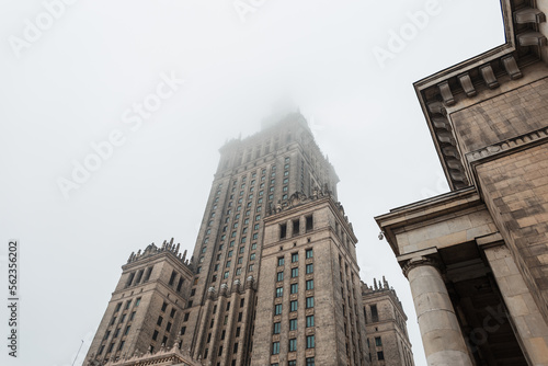 Vintage building Palace of Culture in Poland, Warsaw in the fog. Socialist Realism Architecture