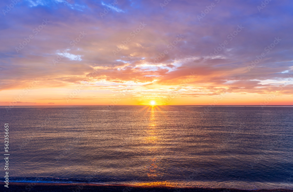 view at sunrise or sunset in sea with nice beach , surf , calm water and beautiful clouds on a background of a sea landscape view at sunrise or sunset in sea with nice beach , surf , calm water and beautiful clouds on a background of a sea landscape