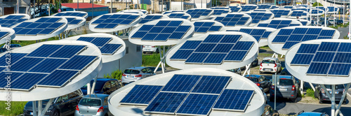 solar power plant with big antennas on a parking for charging electrocars, car energy of future photo