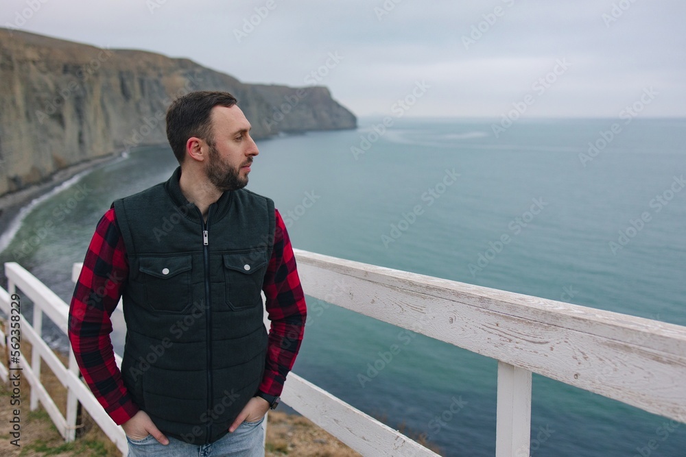 Man walking in nature, beautiful sea view, hiking, adventure, active and healthy lifestyle, ecotourism.