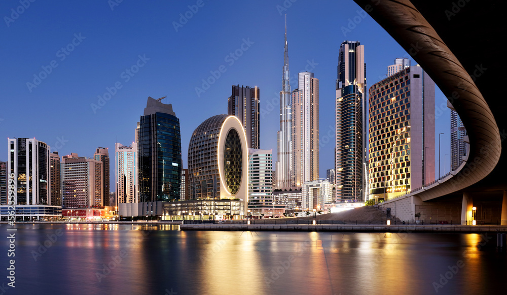 Fototapeta premium Panaroma of Dubai skyline with Burj khalifa and other skyscrapers at night from Al Jadaf Waterfront, UAE