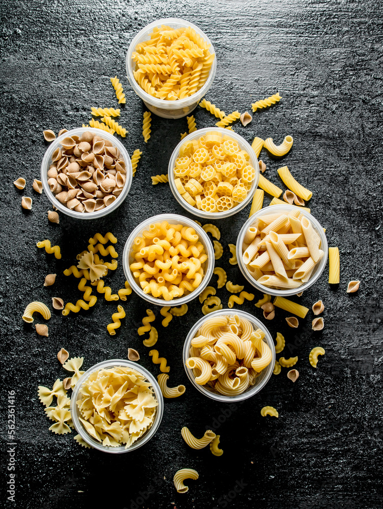 Pasta background. Different dry pasta in bowls. Pasta background. Different dry pasta in bowls.