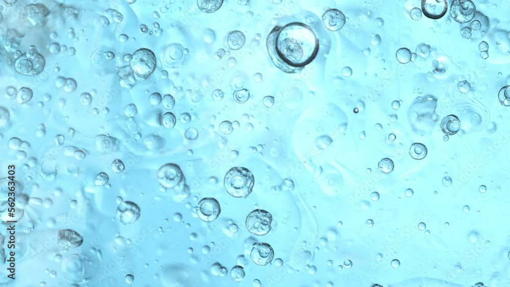 Super Slow Motion Shot of Oil Bubbles Moving in Water on Light Blue Gradient Background at 1000fps. Super Slow Motion Shot of Oil Bubbles Moving in Water on Light Blue Gradient Background at 1000fps.