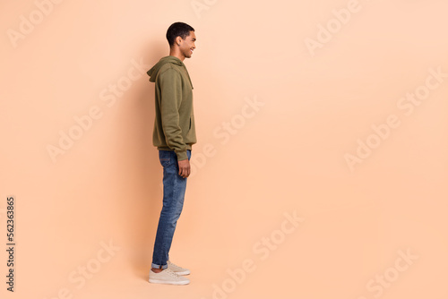 Profile side photo of attractive stylish man wear khaki clothes look empty space cool proposition isolated on beige color background