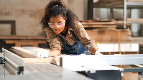 Фотография Portrait, female multiracial carpenter working in woodshop small business