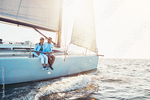 Happy couple, cruise ship and ocean in summer sunshine, love and romance on outdoor adventure. Couple, yacht and cruise sea with waves, bonding or peace with luxury, lifestyle and travel for vacation