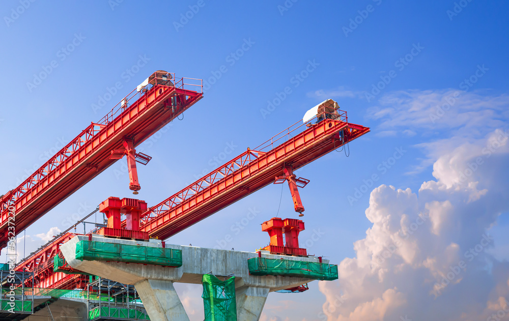 Metal launching gantry Structure for installing concrete typical Segment Joint on foundation of elevated expressway in road Construction site against blue sky background