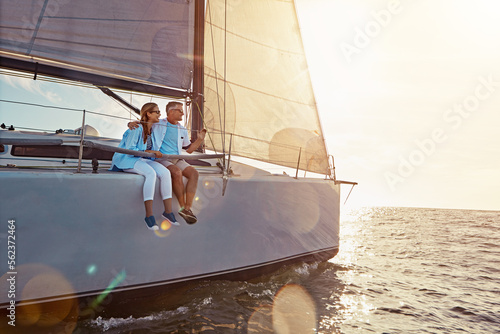 Holiday, relax and couple on a yacht in the ocean for adventure, freedom and sailing trip. Travel, summer and mature man and woman on a boat in the sea for a romantic seaside vacation in Greece. photo
