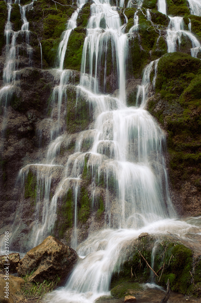 Beautiful front photograph of a wonderful waterfall that runs between mossy rocks Beautiful front photograph of a wonderful waterfall that runs between mossy rocks
