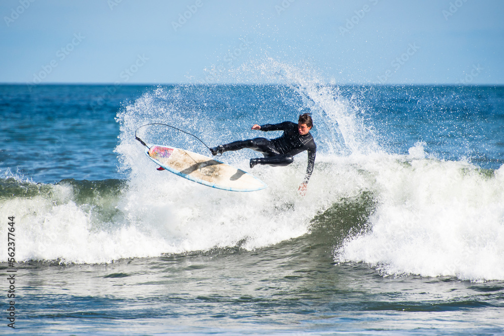 Man surfing hurricane surf, Point Judith, Narragansett, Rhode Island, USA Man surfing hurricane surf, Point Judith, Narragansett, Rhode Island, USA