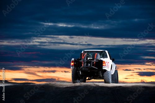 A baja style rally truck drives through the sand at Knolls Recreation Area, UT photo