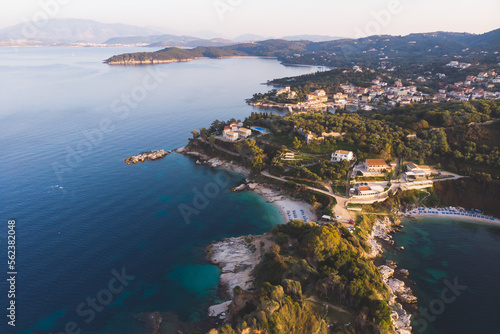 Fototapeta Naklejka Na Ścianę i Meble -  Aerial drone view of Kassiopi, village in northeast coast of Corfu island, Ionian Islands, Kerkyra, Greece in a summer sunny day, with marina, town, beach and castle