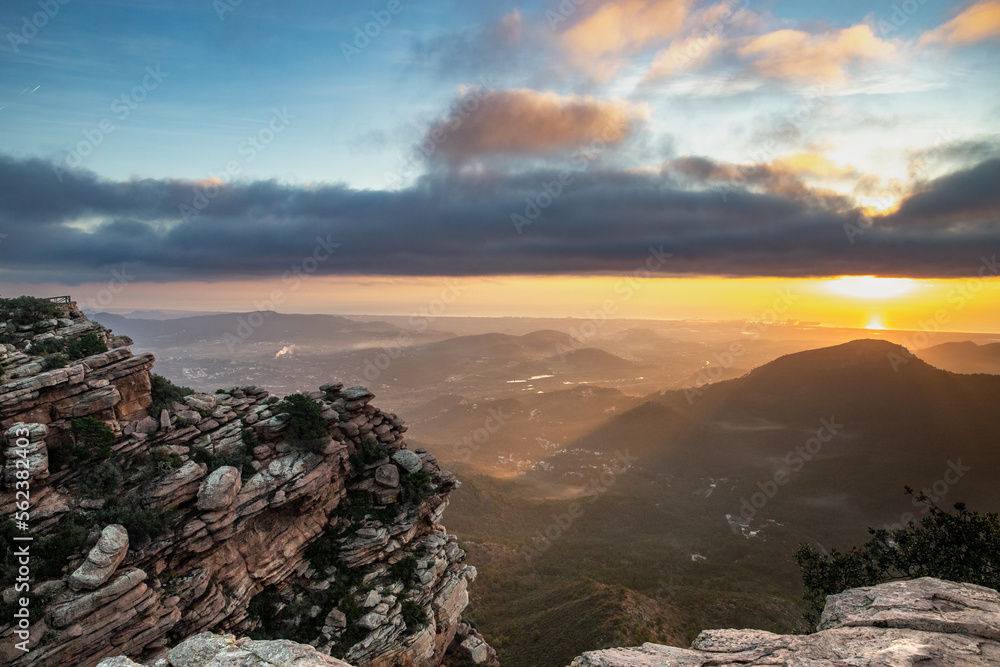 Sunrise over the sea seen from the mountain. Sunrise from the El Garbí viewpoint, in Valencia. Sunbeams breaking through the mist. Sierra Calderona Natural Park.