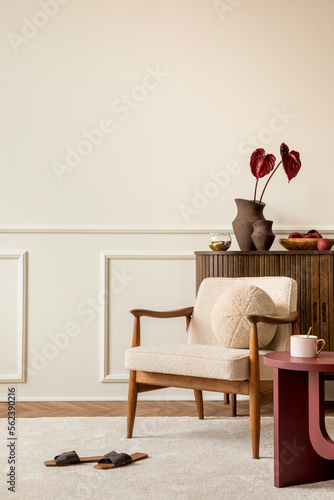 Foto Aesthetic composition of living room interior with copy space, boucle armchair, claret coffee table, round pillow, wooden sideboard, beige rug and personal accessories
