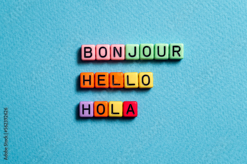 Bonjour hello hola - word concept on cubes photo