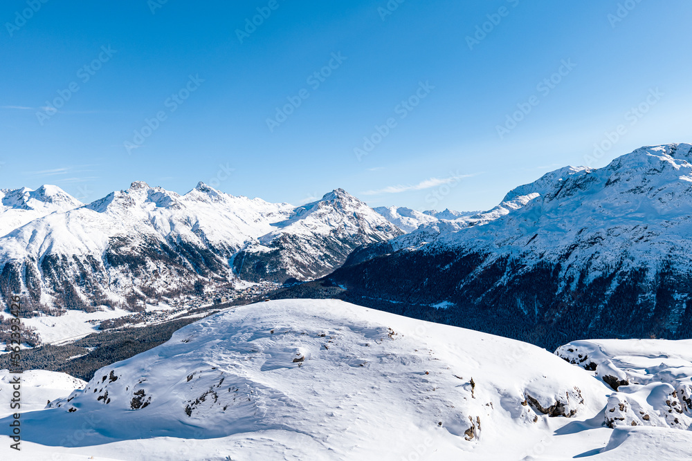 View of winter snowy mountain landscape on a sunny day around St. Moritz, Switzerland.