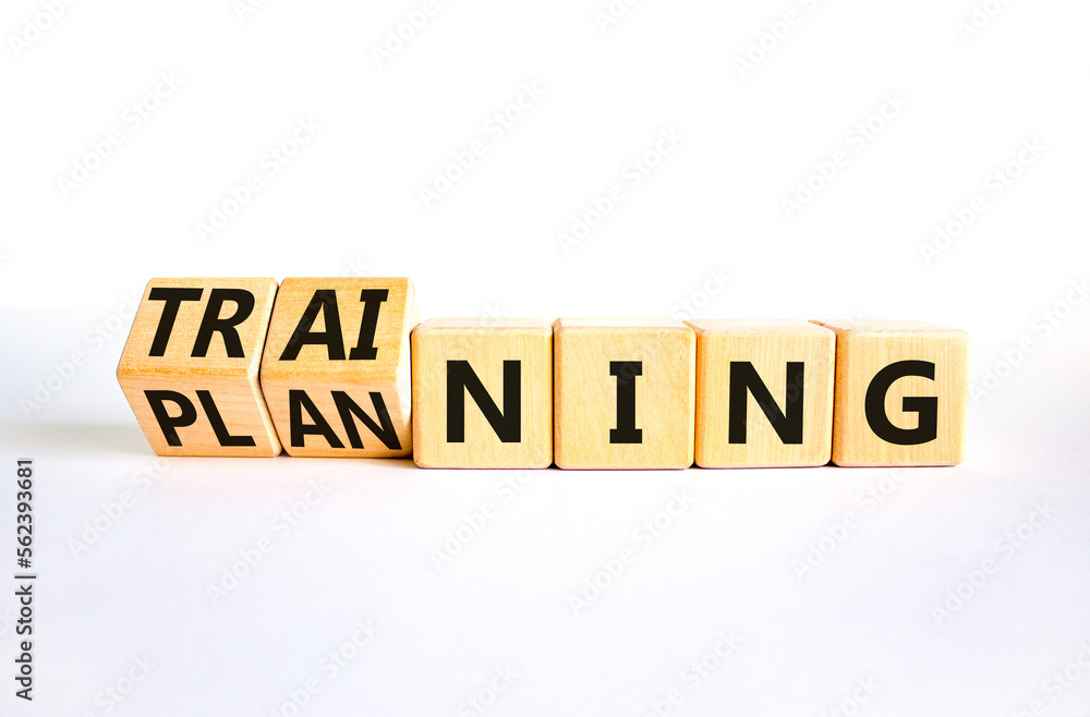 Training and planning symbol. Concept word Training and Planning on wooden cubes. Beautiful white table white background. Business training and planning concept. Copy space. Training and planning symbol. Concept word Training and Planning on wooden cubes. Beautiful white table white background. Business training and planning concept. Copy space.