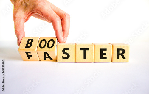 Booster and faster symbol. Concept word Booster Faster on wooden cubes. Businessman hand. Beautiful white table white background. Business booster and faster concept. Copy space.