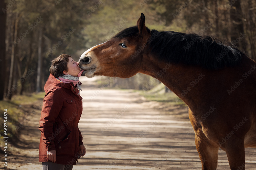 Girl with her beautiful bay horse