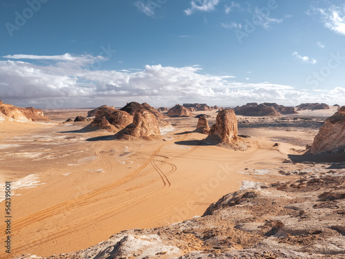 The view of car tracks in the sand of Valley of Agabat, White Desert, Egypt.