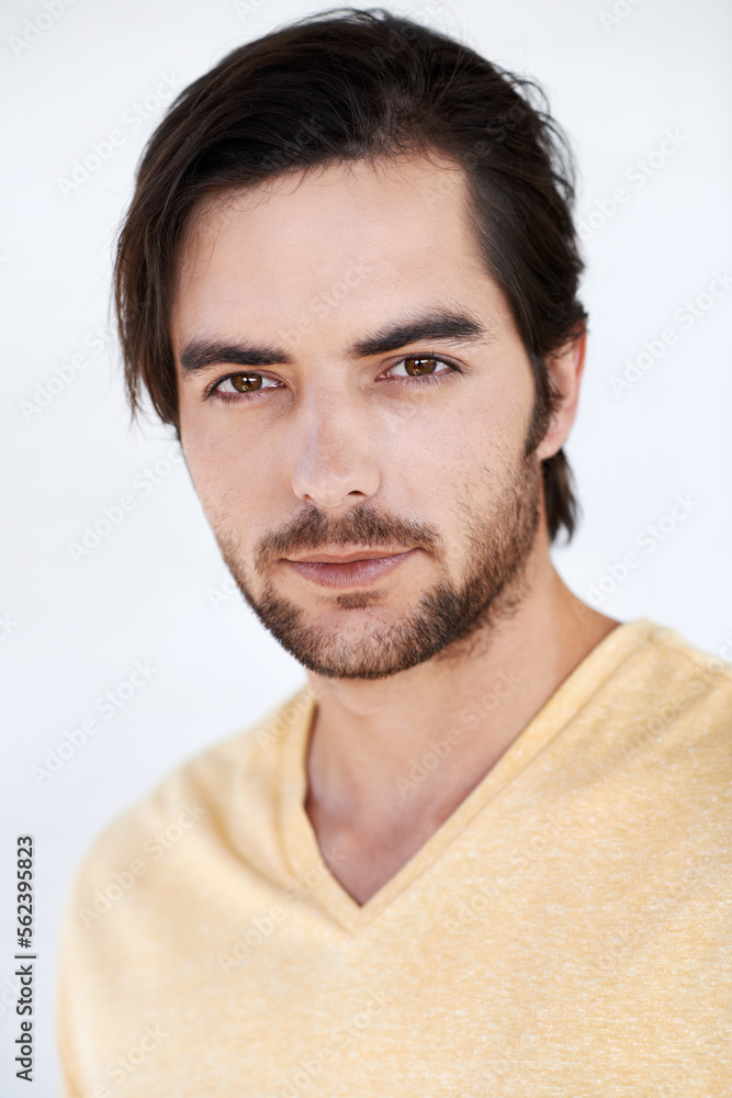 Portrait, fashion and model with a handsome man in studio on a gray background wearing a t-shirt. Face, style and casual with a young male model posing to promote contemporary or trendy clothes Portrait, fashion and model with a handsome man in studio on a gray background wearing a t-shirt. Face, style and casual with a young male model posing to promote contemporary or trendy clothes