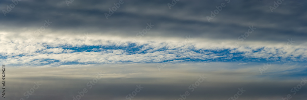 Rain clouds against the background of white clouds and blue morning sky. Rain clouds against the background of white clouds and blue morning sky.