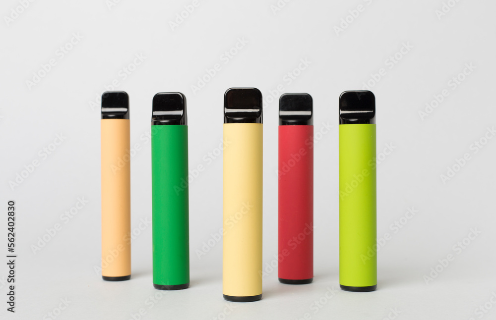 Disposable electronic cigarettes on color background Disposable electronic cigarettes on color background