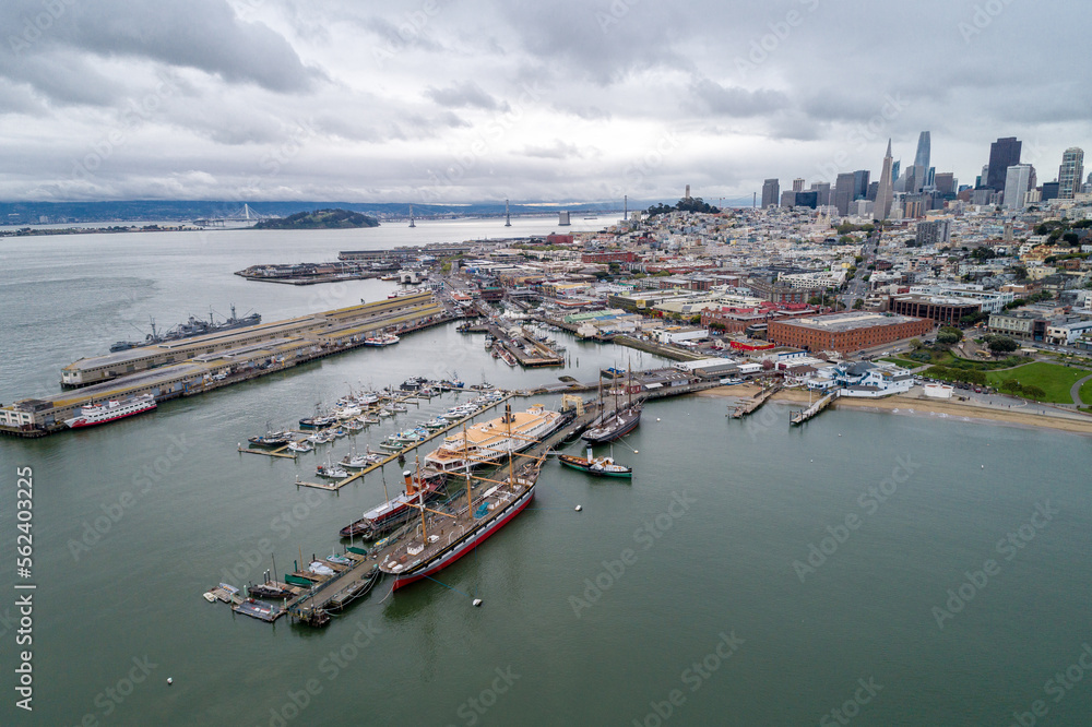 Aquatic Park Pier , Cove and Municipal Pier in San Francisco. Maritime National Historic Park in Background. Cityscape of San Francisco. California. Drone