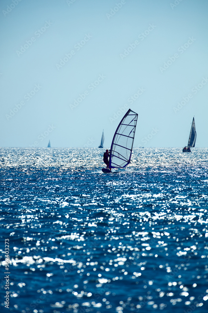 Windsurfer on the open sea ocean waters. Windsurfer on the open sea ocean waters.