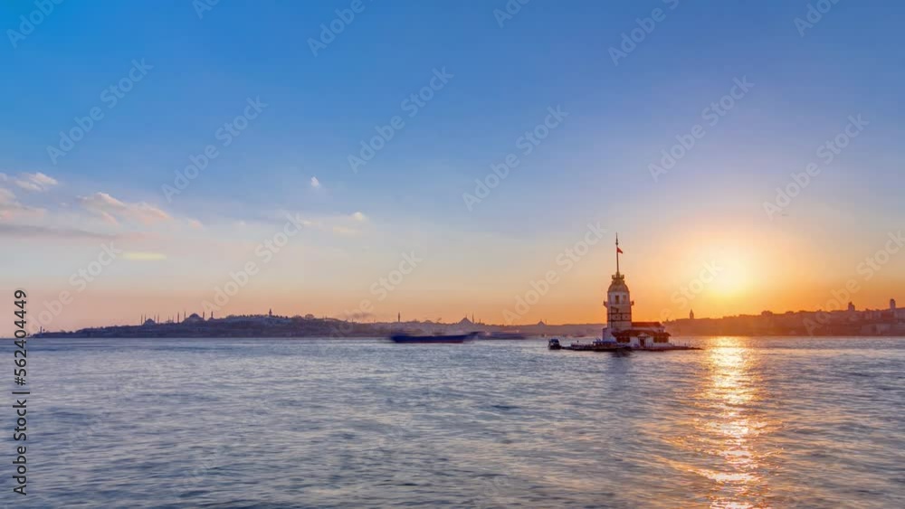 Maidens tower with beautiful sunset panoramic timelapse in Istanbul, turkey, kiz kulesi tower. City skyline on background with reflection on Bosforus water Maidens tower with beautiful sunset panoramic timelapse in Istanbul, turkey, kiz kulesi tower. City skyline on background with reflection on Bosforus water