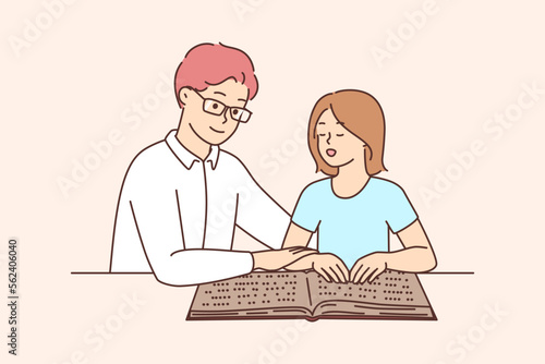 Male tutor teach child reading braille
