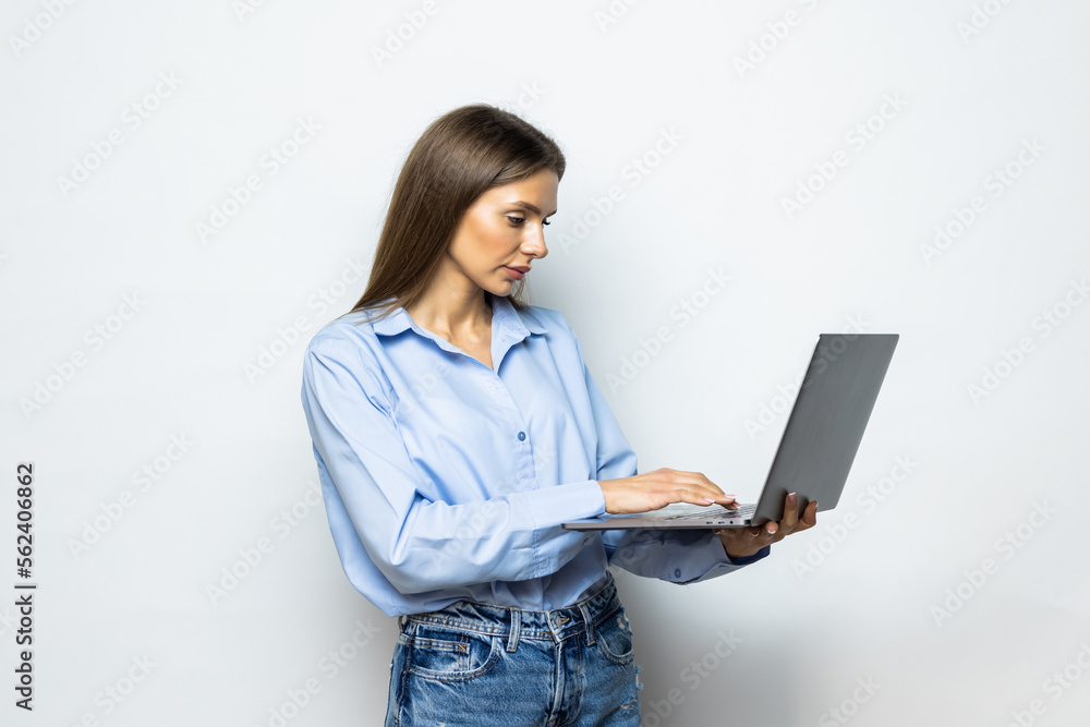 Portrait of a businesswoman working on laptop computer isolated over white background Portrait of a businesswoman working on laptop computer isolated over white background