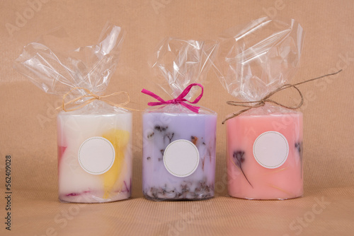 Billede på lærred Product photograph of colourful natural wax candles packed in cellophane on brow