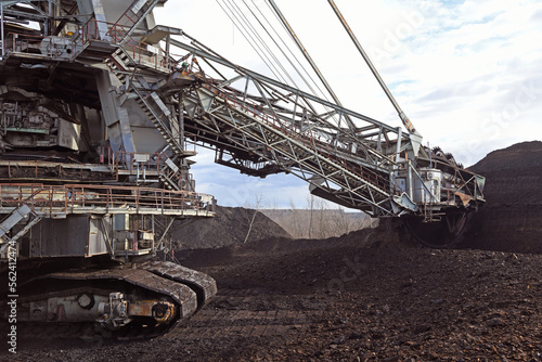 Bucket-wheel excavator during excavation at the surface mine. Huge excavator on open pit mine.