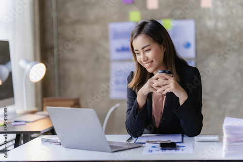 Asian businesswoman working with calculator to analyze business data and financial concept Female accountant working with computer and for business and financial expenses charming asian girl