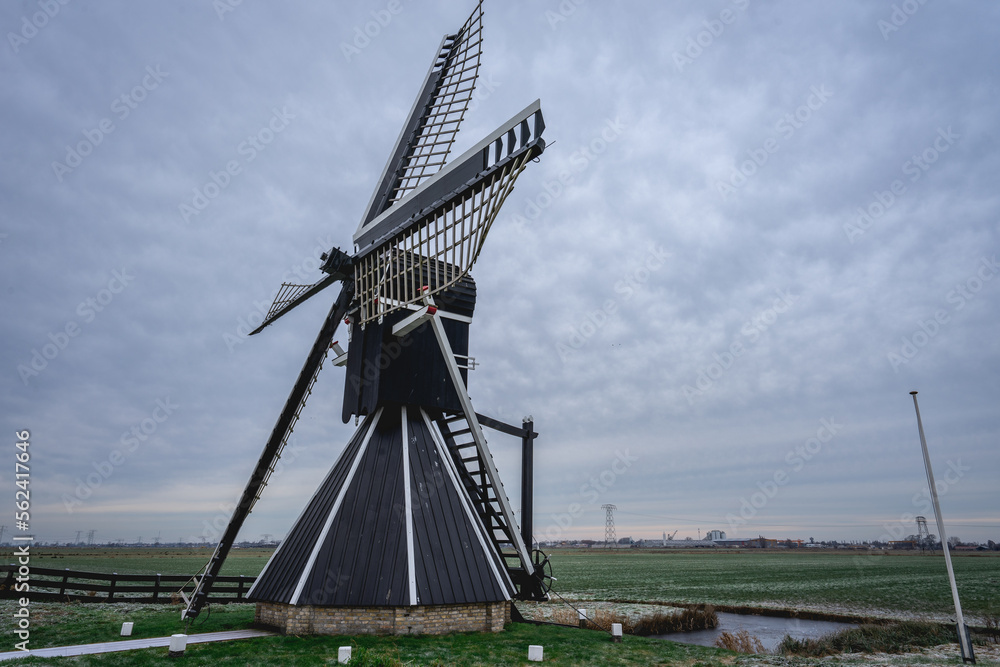 Obraz premium Mellemolen, dutch windmill in Akkrum, the Netherlands. In the winter with Some snow.