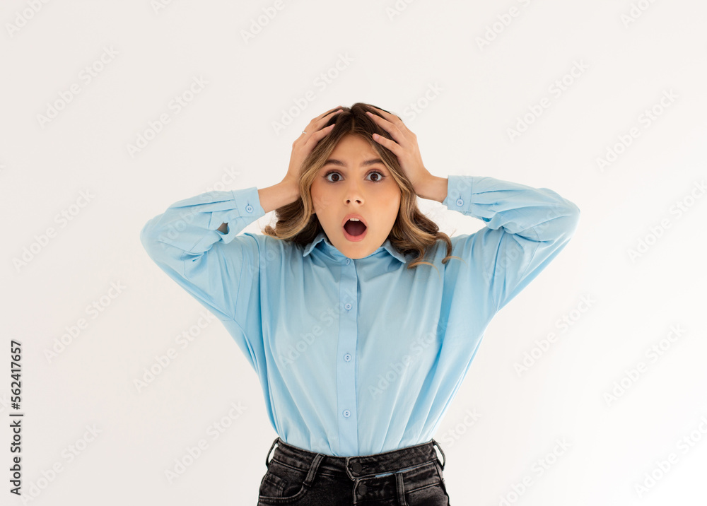 Shocked woman holding hands on head with concerned and anxious face, feeling troubled, facing big problem and looking indecisive at camera, white background. Shocked woman holding hands on head with concerned and anxious face, feeling troubled, facing big problem and looking indecisive at camera, white background.