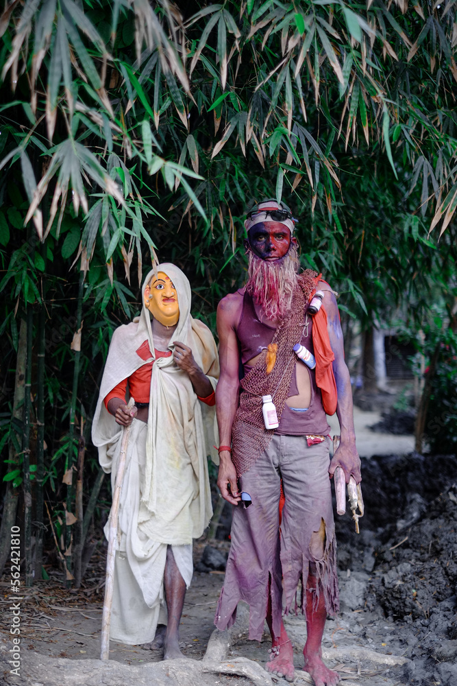 Hindu religious village people celebrating gajan festival wearing colourful costumes 