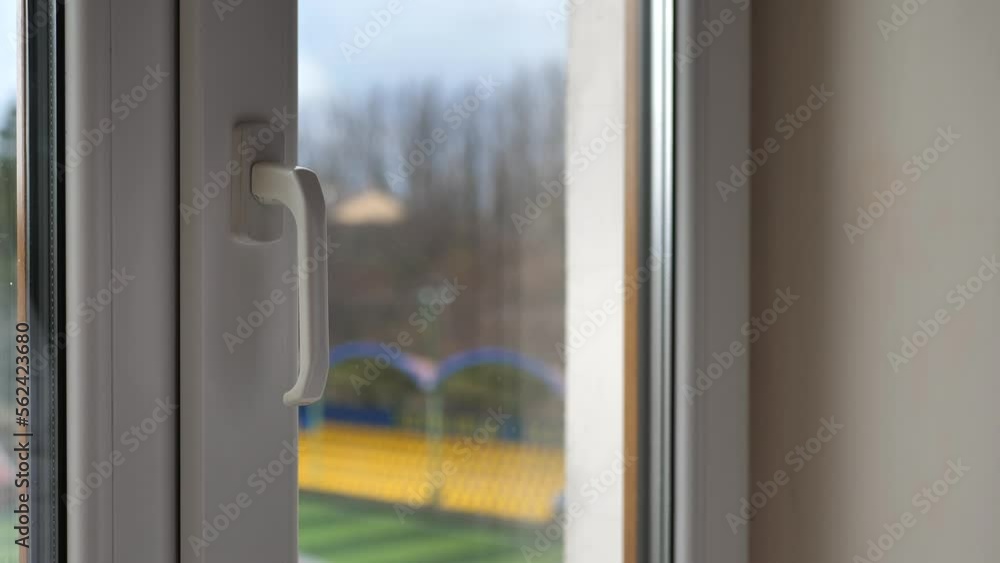 Businessman's hand closes a large window in the office Businessman's hand closes a large window in the office